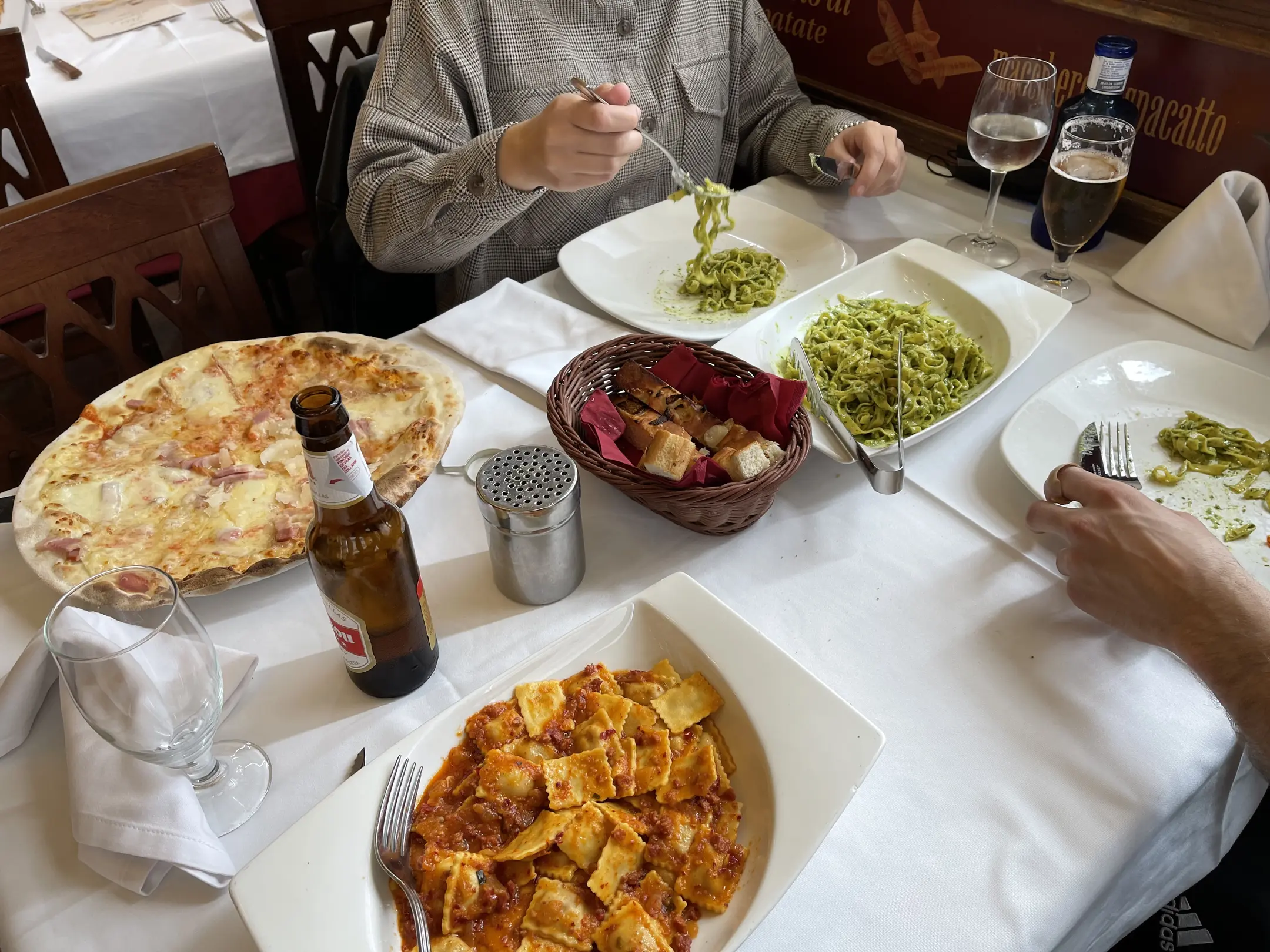 bowl(0.90), bottle(0.90), person(0.88), wine glass(0.87), chair(0.86), pizza(0.78), wine glass(0.73), dining table(0.58), cup(0.57)